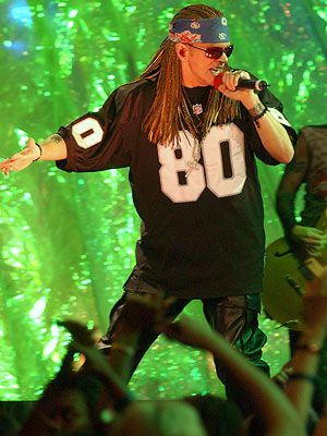 Axl Rose | Rose's Thorns Upon his triumphant return to the stage in 2002, the nearly unrecognizable Guns N' Roses frontman sported shades, braids, and a football jersey,