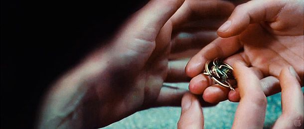 The Hunger Games | What: In the book, Katniss receives her iconic mockingjay pin from schoolmate Madge Undersee. (The pin originally belonged to Madge's aunt, who died in an