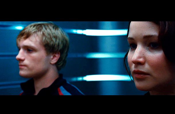The Hunger Games | A memorable shot of the District 12 tributes, who look like they're heading down to show off their skills alongside their other Tributes. One of
