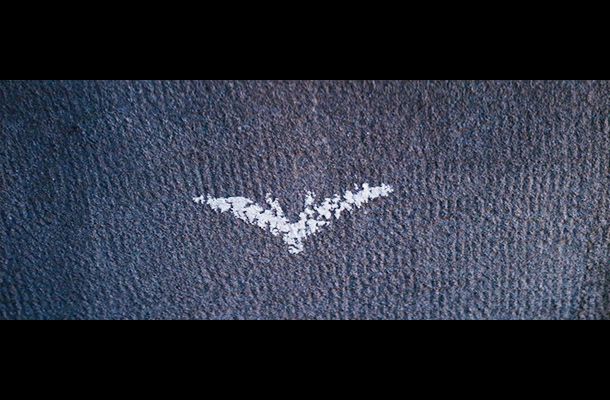 The Dark Knight Rises | The vision of the Bat signal replicated in street chalk is clearly important for the movie &mdash; it was a key aspect of this week's