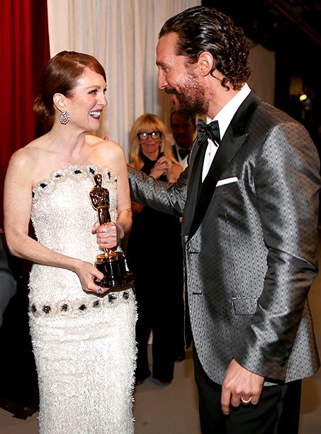 Best Actress Winner Julianne Moore is congratulated by presenter Matthew McConaughey