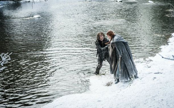Alfie Allen as Theon Greyjoy and Sophie Turner as Sansa Stark
