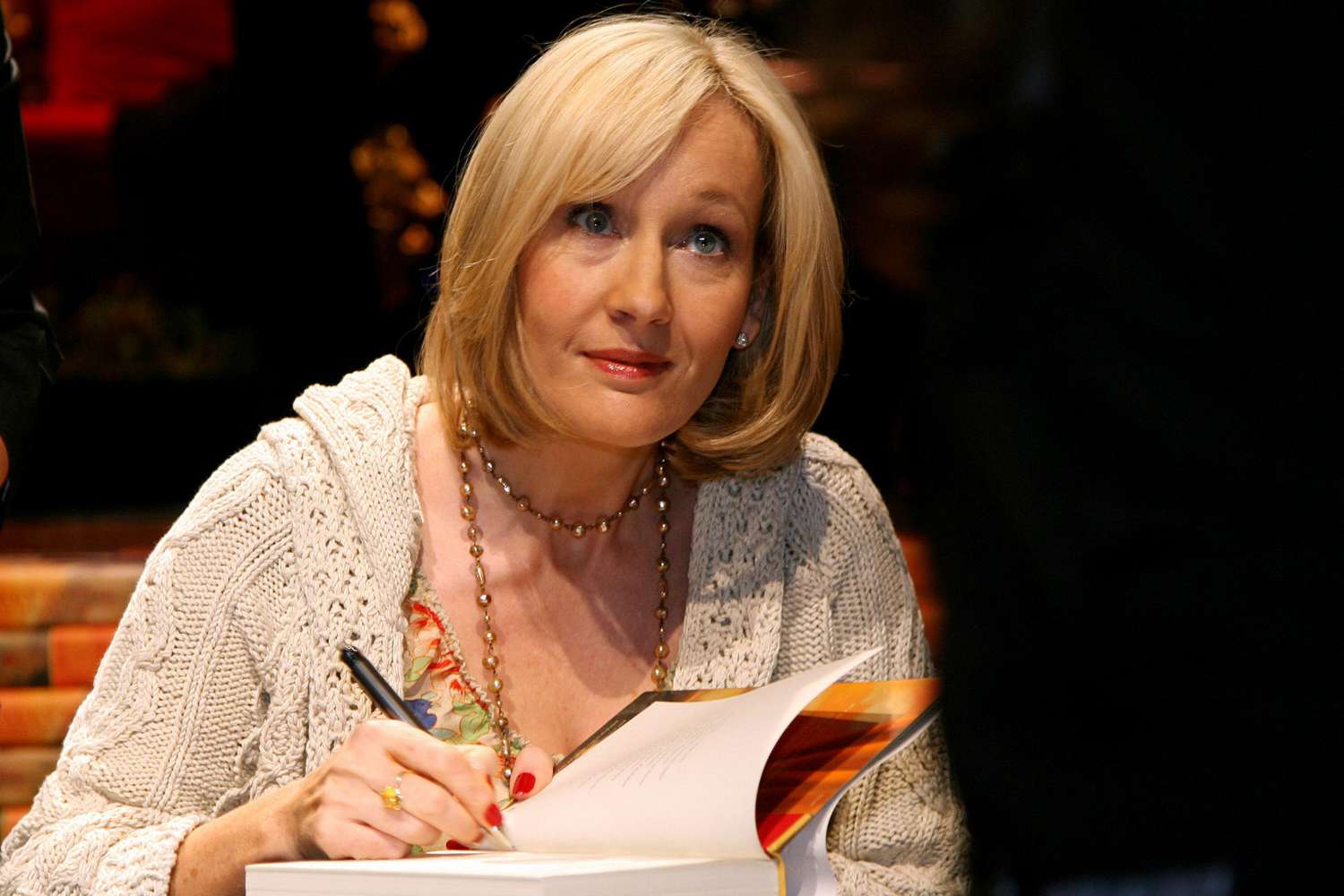 British writer J.K. Rowling signs copies