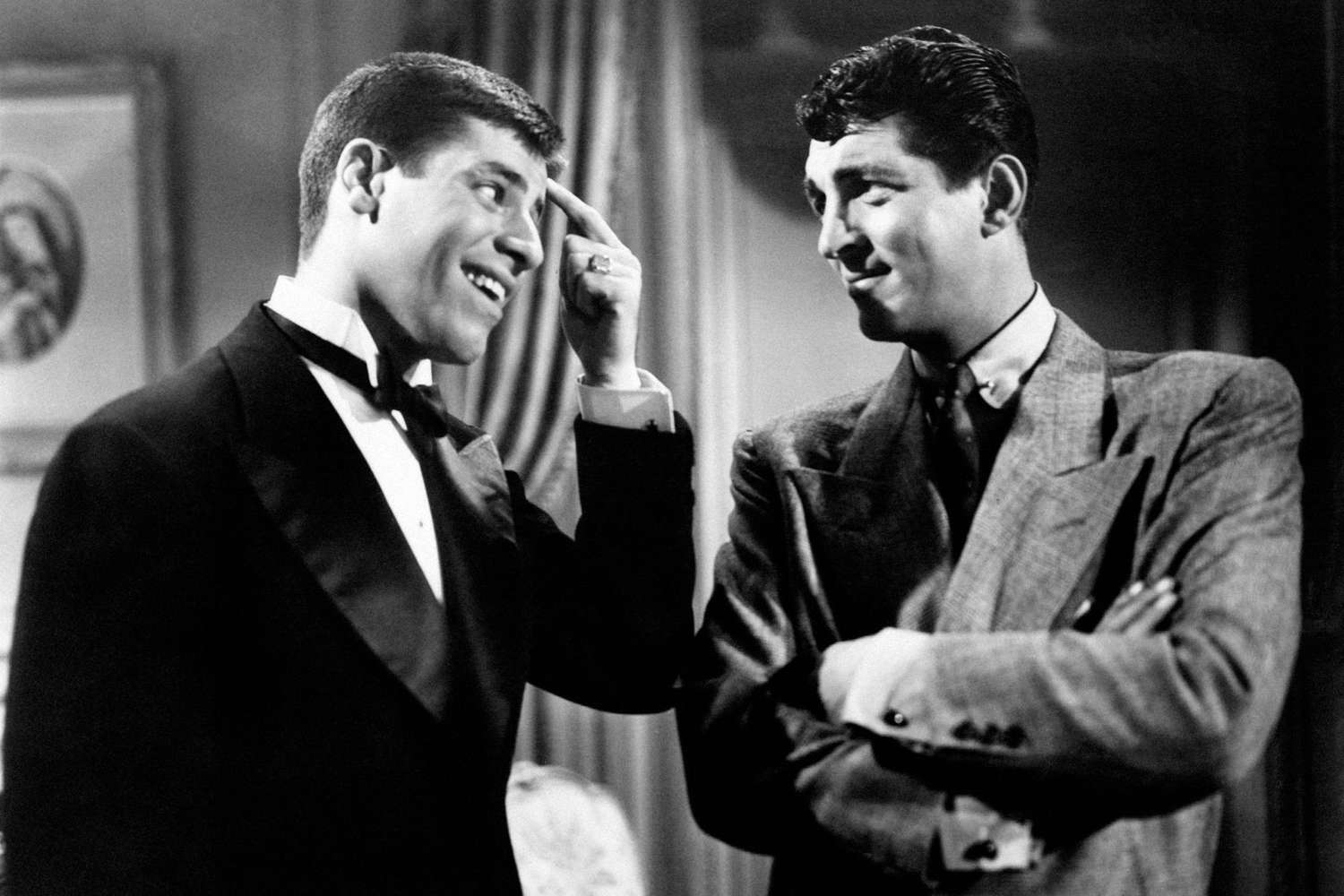 Dean Martin looks ironically Jerry Lewis who touches himself the brow