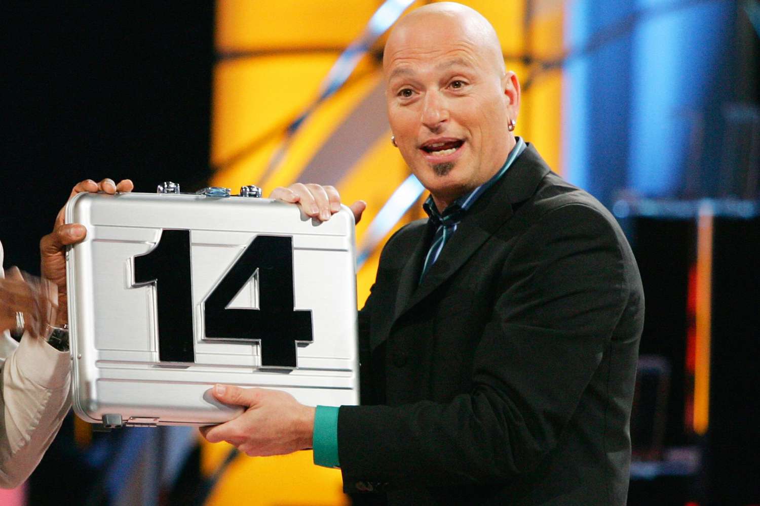 Pictured: (l-r) Contestant, Host Howie Mandel