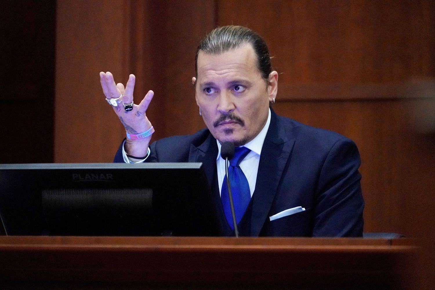 Actor Johnny Depp sits to testify in the courtroom at the Fairfax County Circuit Courthouse in Fairfax, Virginia, April 25, 2022
