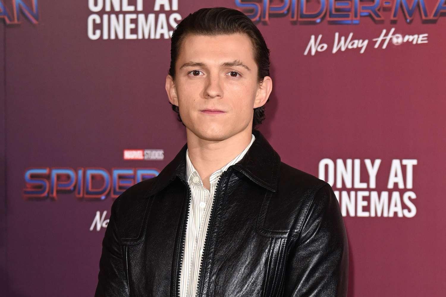 Tom Holland attends a photocall for "Spiderman: No Way Home" at The Old Sessions House on December 05, 2021 in London, England.