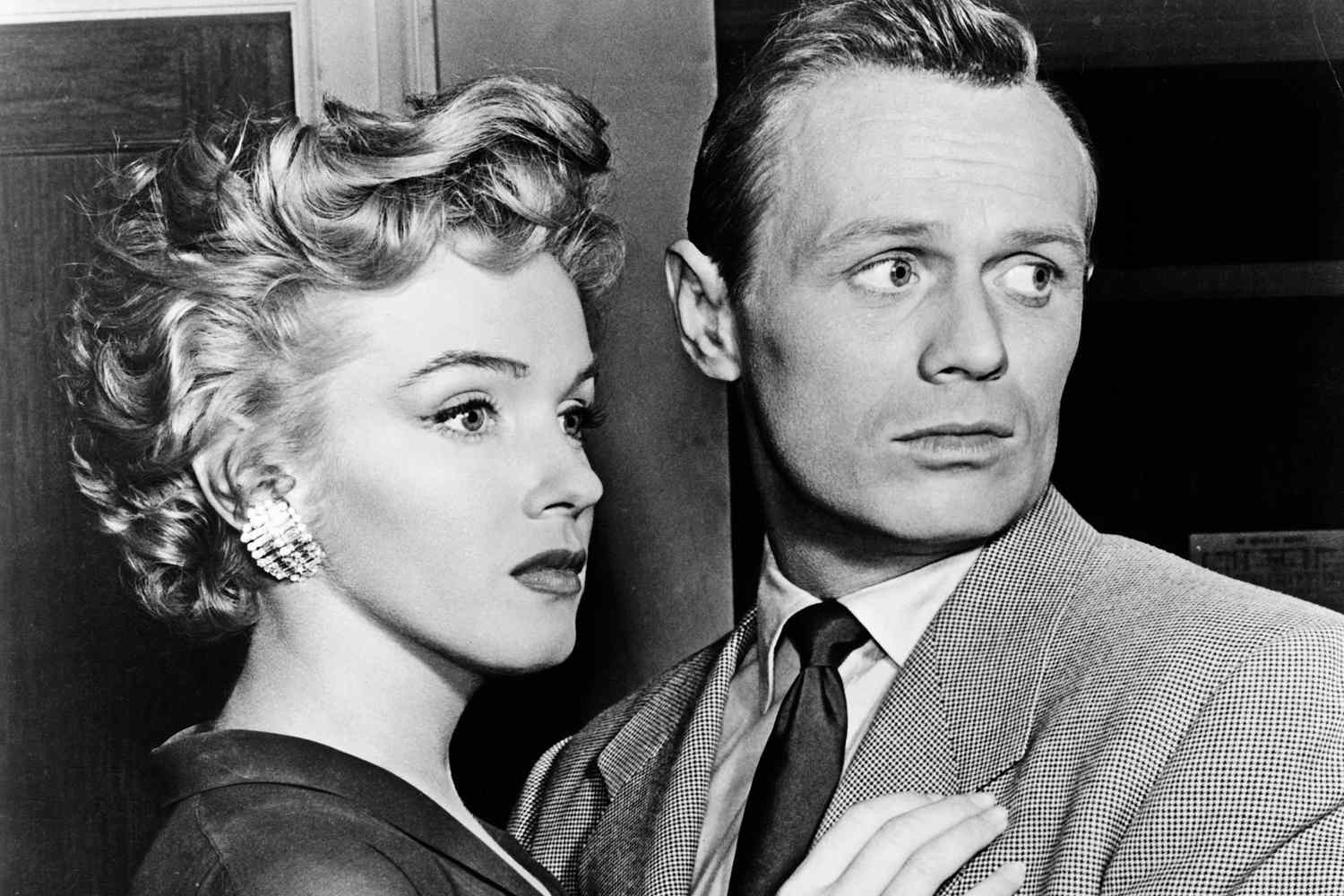 Marilyn Monroe and Richard Widmark embracing in a scene from the film 'Don't Bother To Knock', 1952. (Photo by 20th Century-Fox/Getty Images)