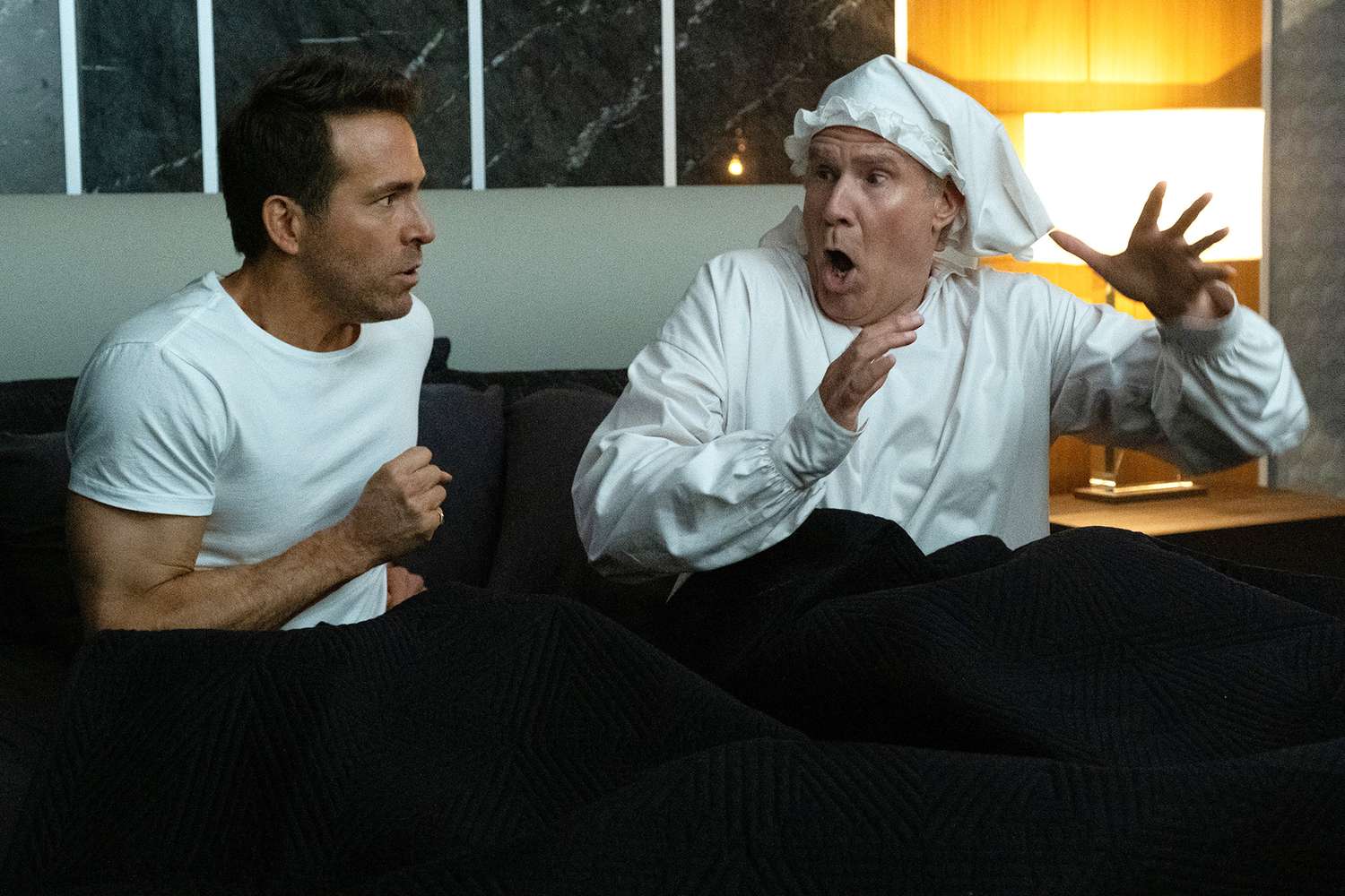 Ryan Reynolds and Will Ferrell in "Spirited," premiering November 18, 2022 on Apple TV+.
