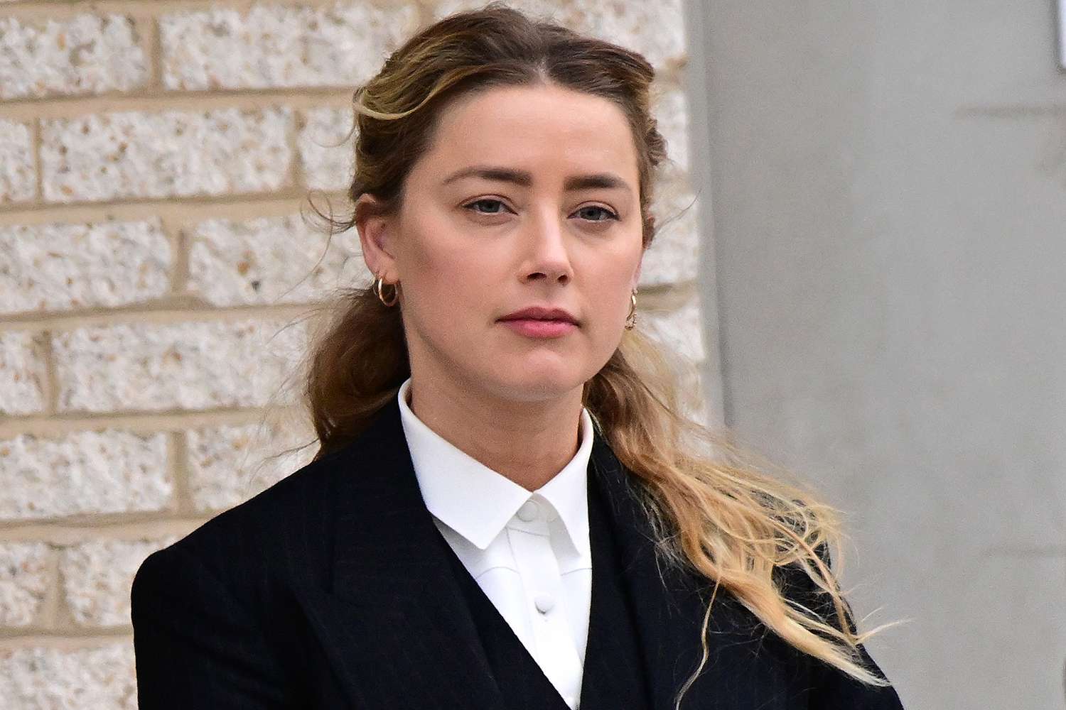 Amber Heard departs following the recess for the day outside court during the Johnny Depp and Amber Heard civil trial at Fairfax County Circuit Court on April 21, 2022 in Fairfax, Virginia.