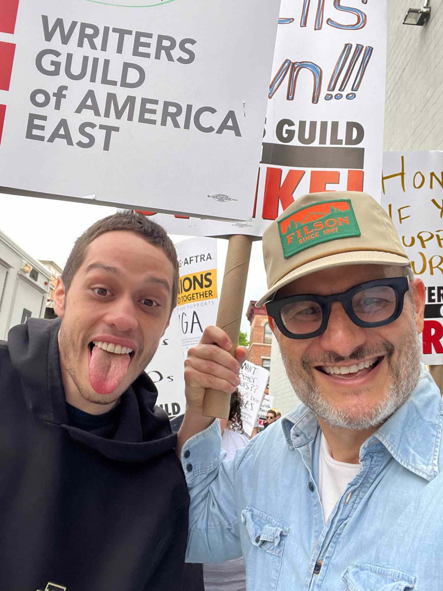 NEW YORK, NEW YORK - MAY 5: Pete Davidson and Judah Miller join members of the Writers Guild of America (WGA) and its supporters to picket outside Silvercup Studios on May 5, 2023 in New York City. Writers Guild of America members have gone on strike in a contract dispute with studios and streaming services over lowering wages, residuals and the future of AI in entertainment. (Photo by Bruce Glikas/Getty Images)