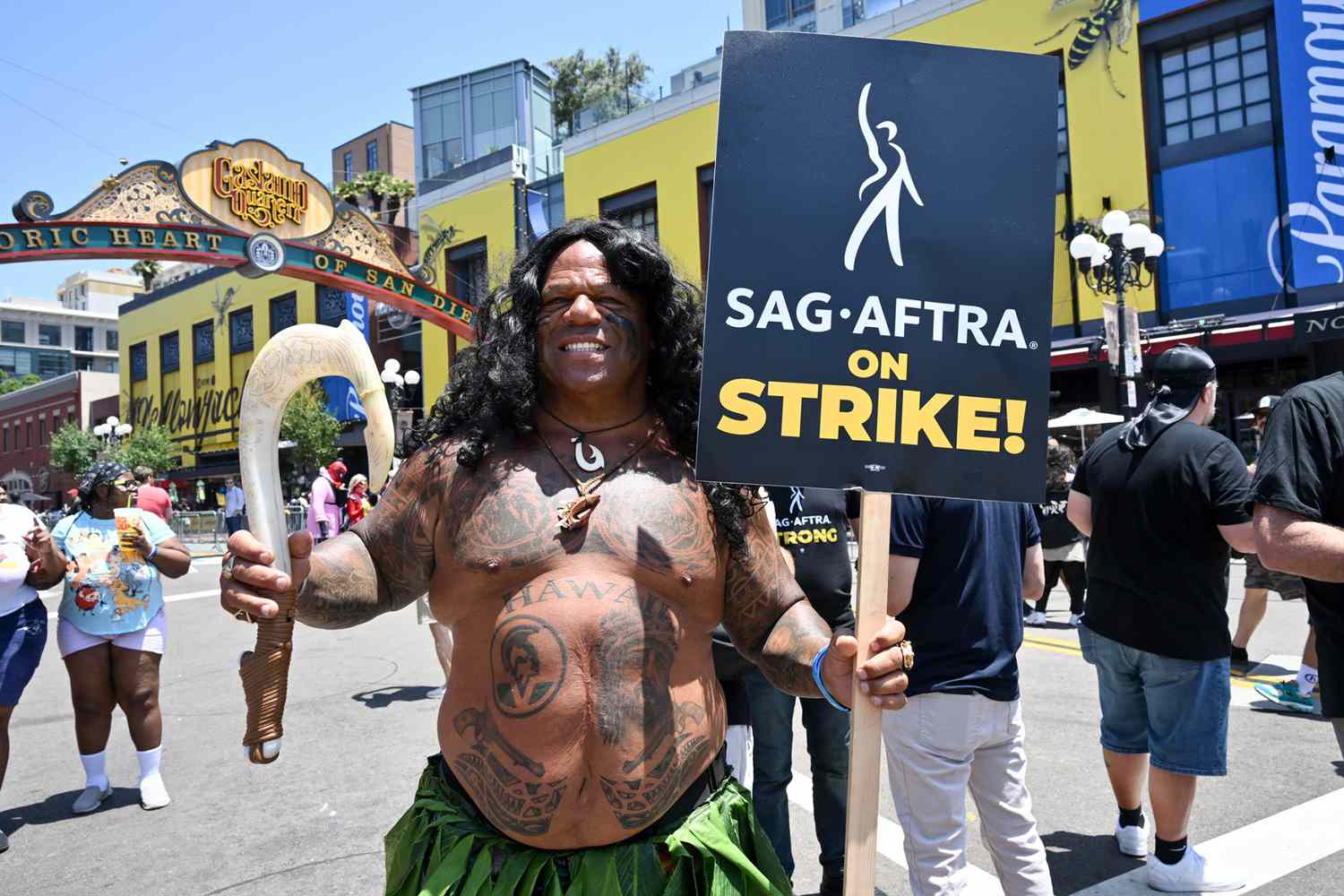 Cosplayer Darrell Waterford dressed as Maui from "Moana" protests alongside members of SAG-AFTRA at 2023 Comic-Con in San Diego