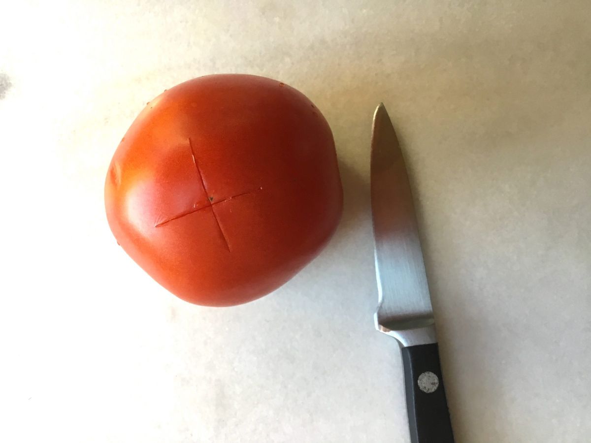 scored tomato and knife