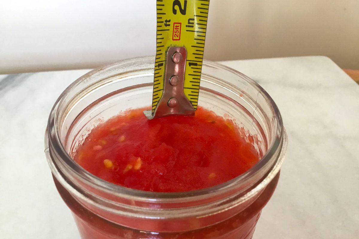 tomatoes in can with measuring tape