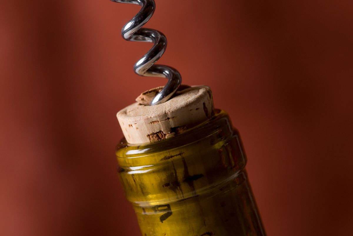A wine cork being removed from a bottle