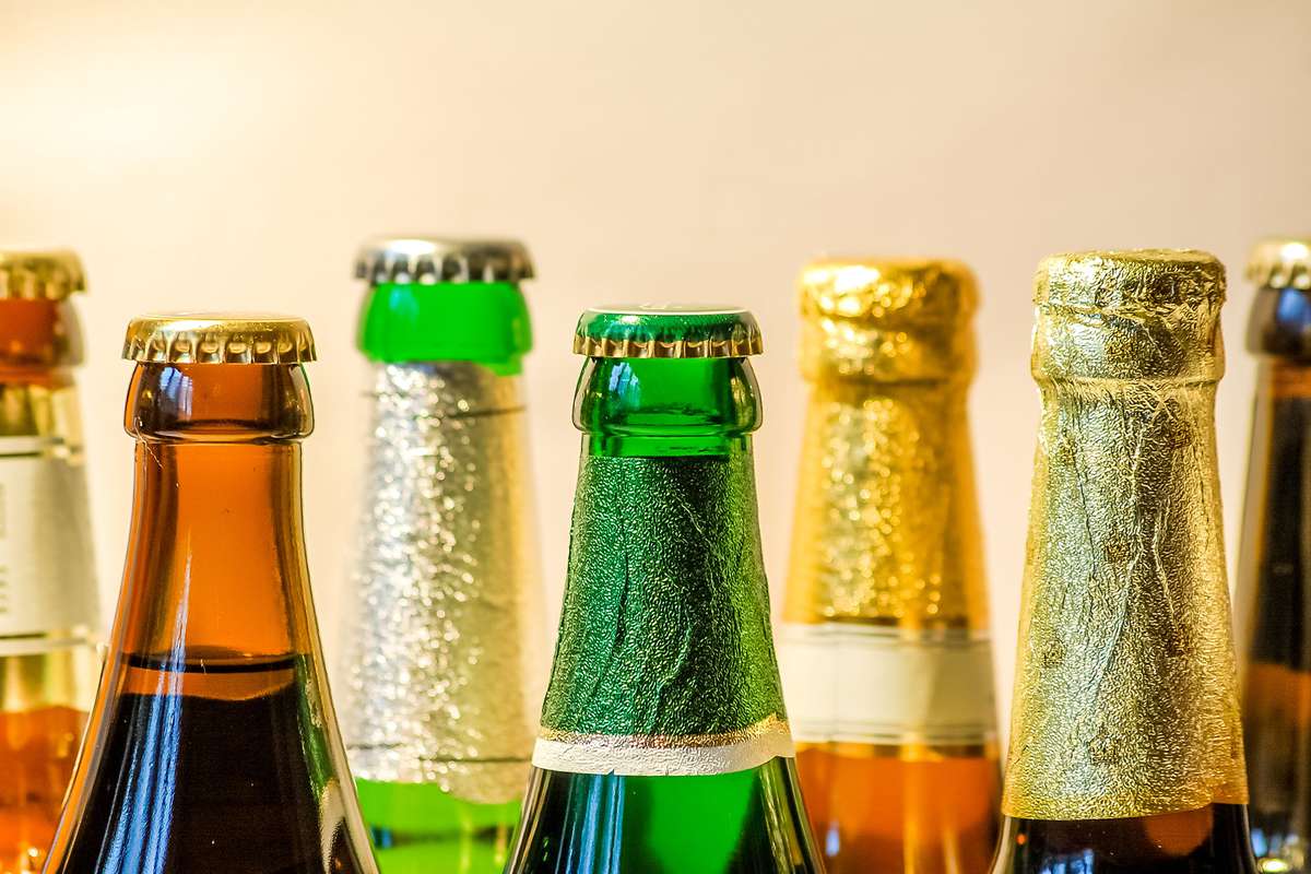 Close-Up Of Beer Bottles Against Wall