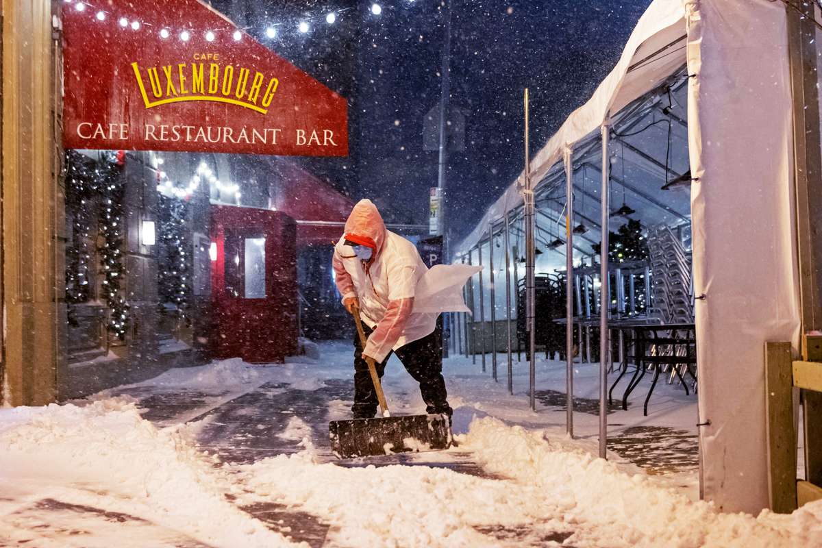 Restaurant Employee Shoveling Snow