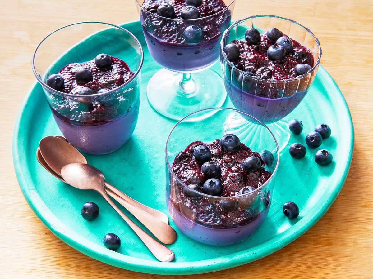 Dessert glasses of blueberry panna cotta with blueberry chia pudding