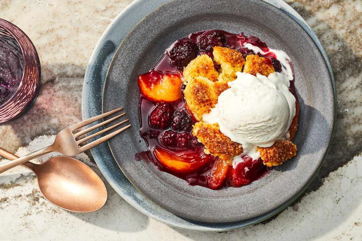 Plated portion of cobbler topped with a scoop of ice cream