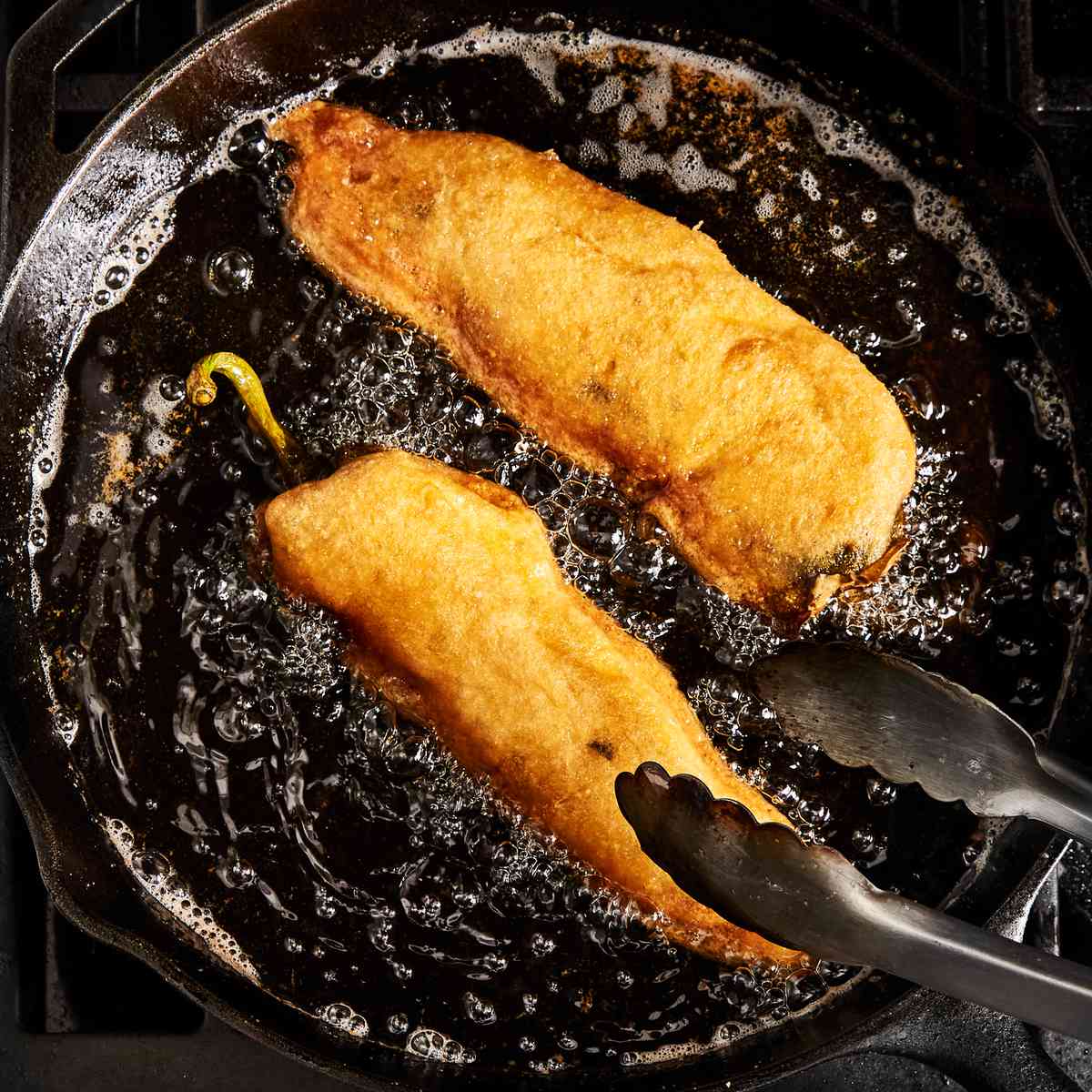 frying chiles rellenos