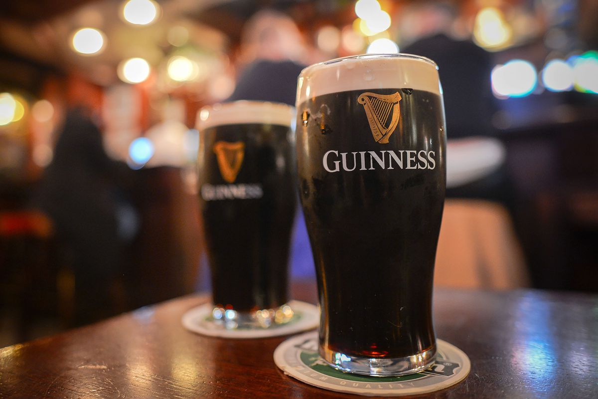 Two pints of Guinness in a taproom