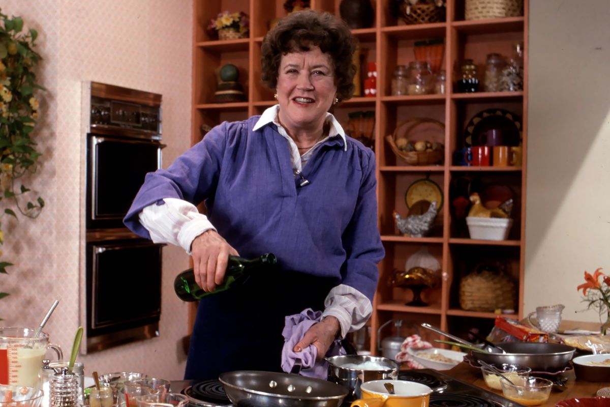 Julia Child cooks in a kitchen