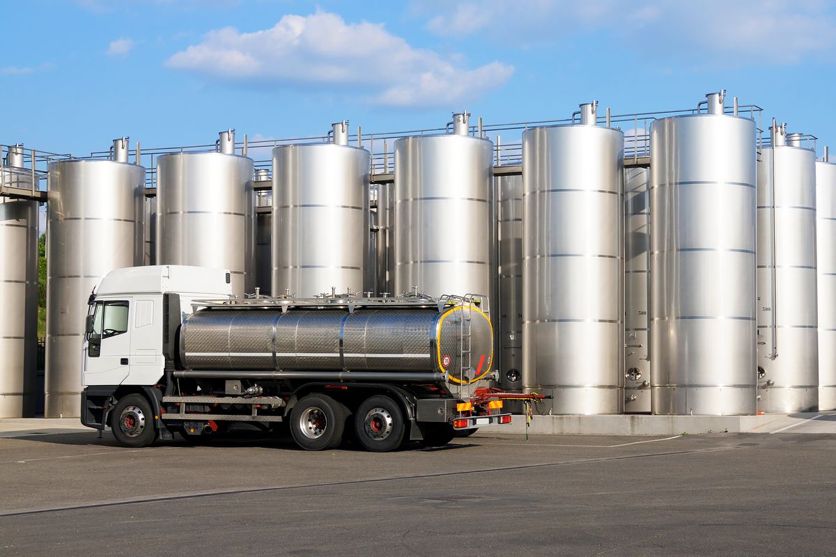 A tanker truck sits parked before a wine storage facility