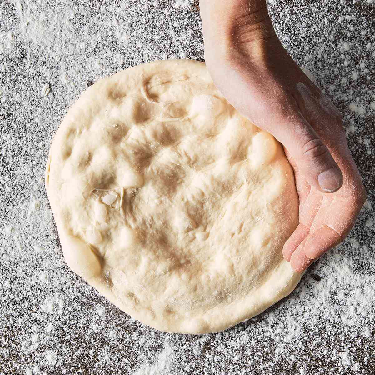 c-shape hand on dough