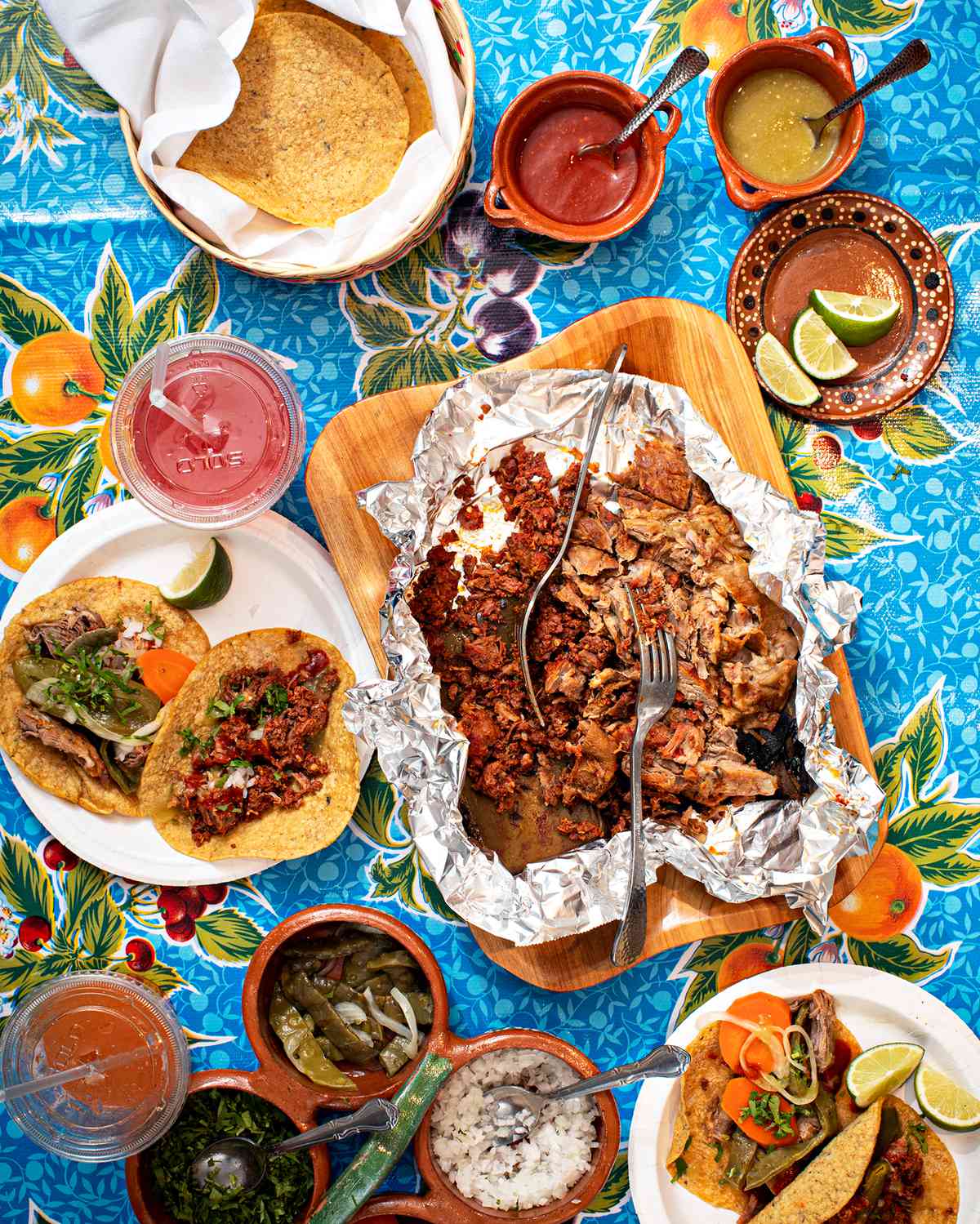 A spread of tacos and South Philly Barbacoa’s signature salsas