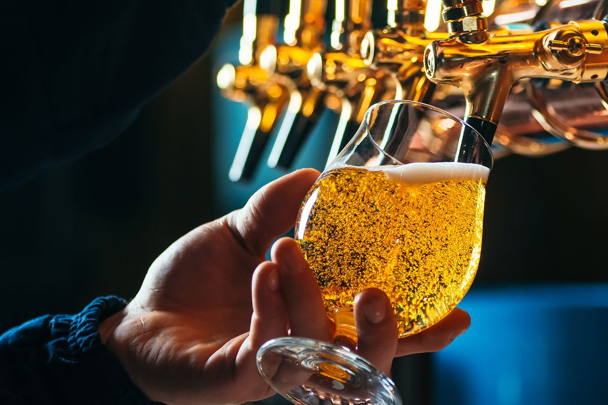 Close up of draft beer pouring into a beer glass