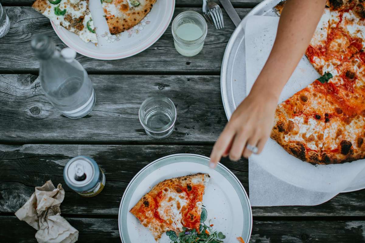 Pizzas on a picnic table from Tinder Hearth Bakery
