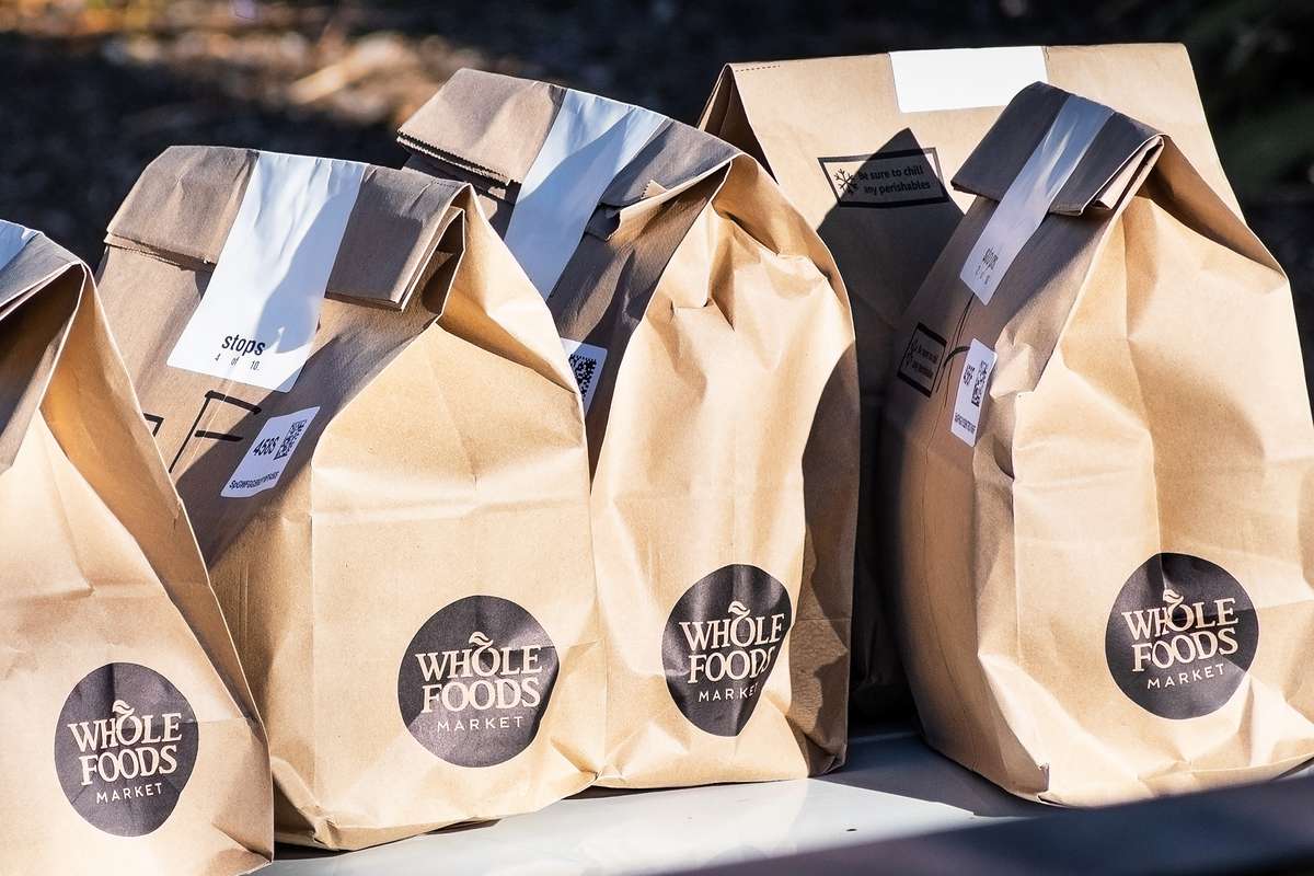 Brown bags with fresh groceries ordered online through Amazon Prime from Whole Foods Market
