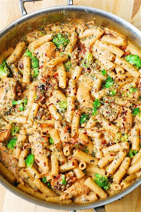 chicken penne pasta with bacon and spinach in creamy tomato sauce