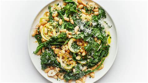 1 bunch broccoli rabe, ends trimmed (about 2 1/2 pounds), 1/2 teaspoon salt, or more to taste, 4 tablespoons olive oil, 1 lemon, very thinly lemony broccoli rabe with white beans