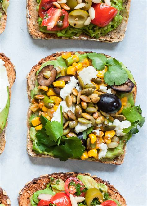 avocado toasts with pan seared corn olives and queso fresco