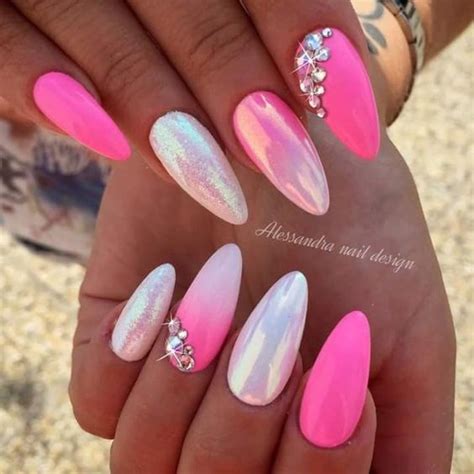One of the coolest nail art looks for valentine's day is this twist on a french manicure with acrylic nails on a pastel pink base color pink valentine's day nail art designs to steal in 2021