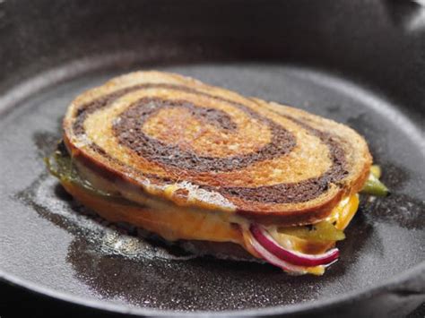 A grilled cheese piled high with hard boiled eggs, bacon, and golden brown ultimate grilled cheese pioneer woman