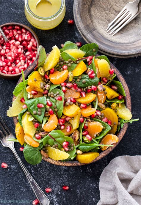 Hearty winter greens salad with warm balsamic dressing, golden beets, pecans, pomegranate, and orange zest is perfect for your next holiday gathering! golden beet and pomegranate salad